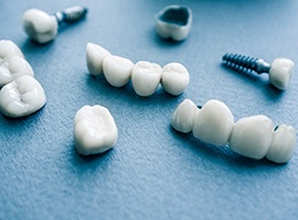 several types of dental implants in Carmichael on blue background